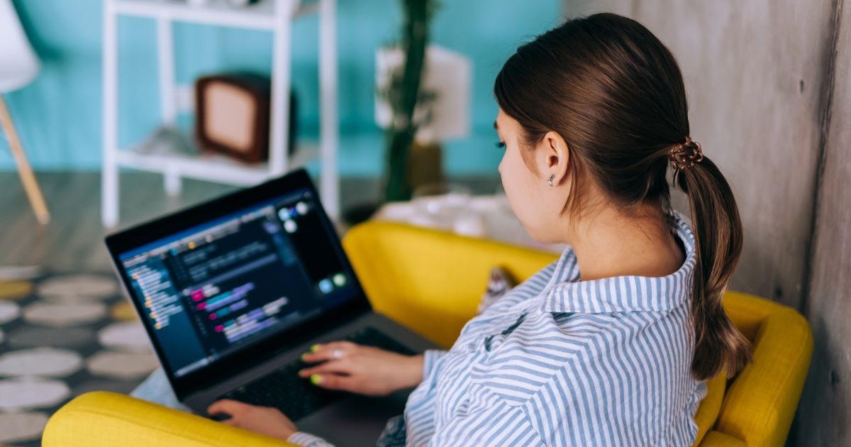 Woman coding on laptop