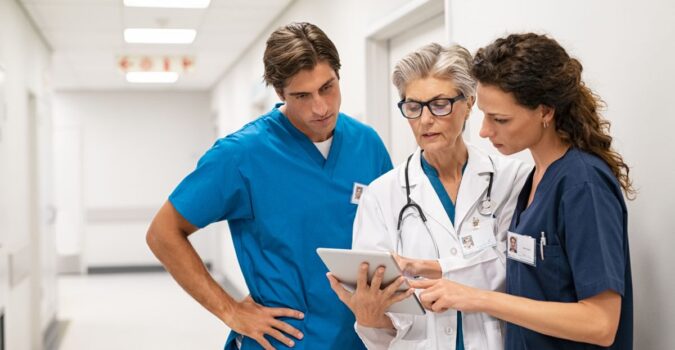 Showing digital transformation in healthcare with a team of providers using a tablet