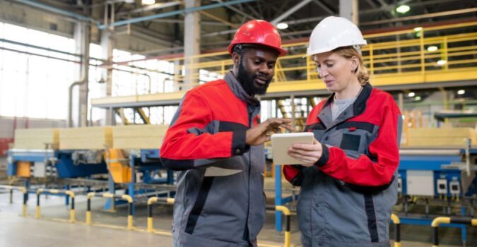 digital transformation in manufacturing with workers looking at a tablet