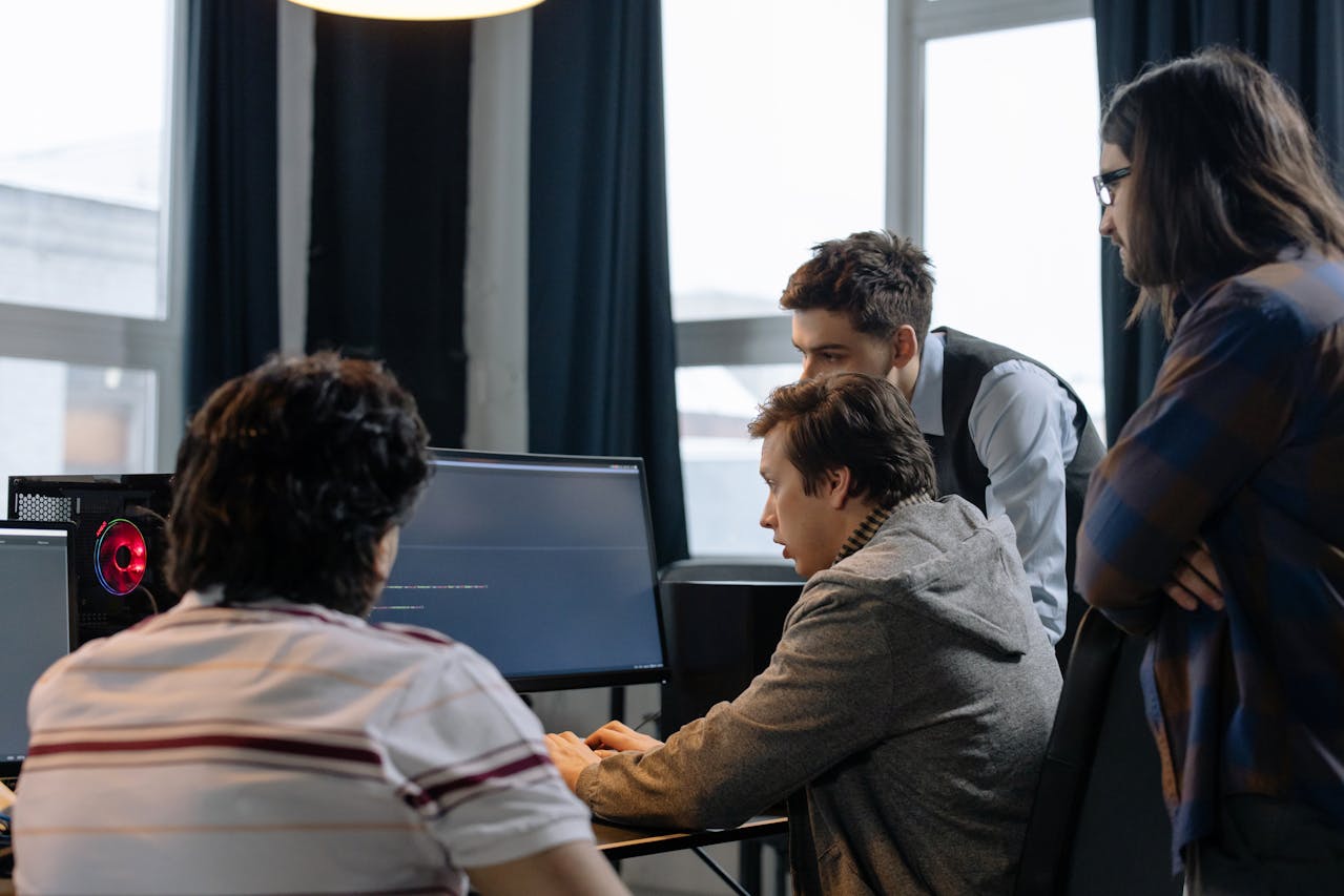 a team of engineers looking at a screen